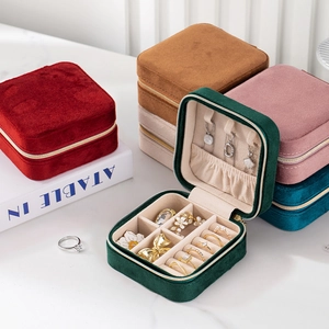 Close-up of velvet jewelry boxes in multiple colors showing texture and zipper