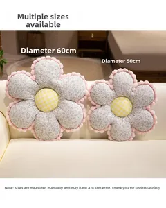 Detail of floral cushions in 50cm and 60cm sizes with pom-pom edges and checkered centers