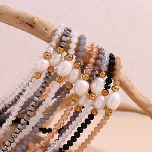 Detailed macro view of baroque pearl bracelets with crystal beads on a wooden branch