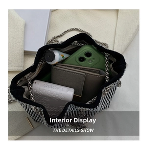 Detail view of the spacious woven bucket bag interior showing daily essentials