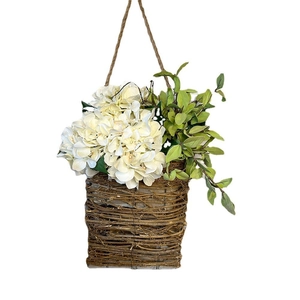 Hanging wicker basket with white artificial hydrangeas and greenery for wall decoration