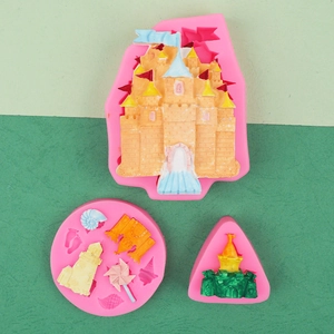 Flat lay of pink silicone molds with colorful finished clay castle and seashell shapes