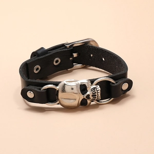 Gothic black leather bracelet featuring a silver skull charm with adjustable buckle closure