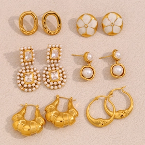 Detailed flat lay of 18K gold plated earring set with pearls and floral designs