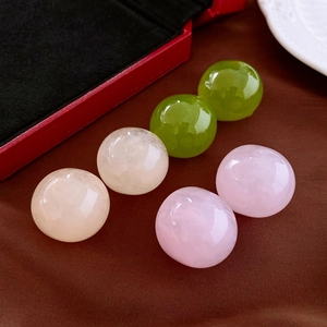 Minimalist resin geometric stud earrings in pink green and white on a vintage display