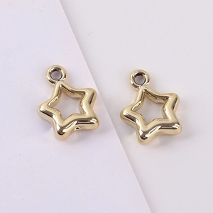 Detailed view of two gold-plated hollow star charms for DIY jewelry and phone chains