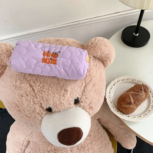 Purple quilted pencil case with floral embroidery and persimmon design on a plush bear