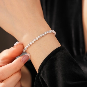 Close-up of elegant pearl bracelet with pavé diamond beads worn on a model wrist