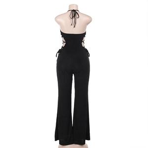 Detail view of black halter backless jumpsuit featuring side lace-up waist cutouts