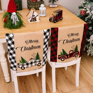 Detail of linen Christmas chair covers with plaid borders and vintage truck motifs