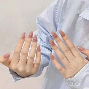 Long almond press-on nails with elegant pink cat-eye gradient and glitter shimmer finish