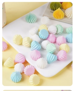 Detailed view of colorful pastel pagoda-shaped faux meringue candies on a tray
