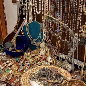 Vintage palace style jewelry collection with gold brooches and layered pearl necklaces