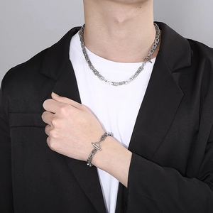 Detail of silver stainless steel chain set with rectangular links and OT toggle clasp on model