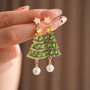 Star-shaped Christmas tree earrings with emerald droplets and elegant white pearl pendants