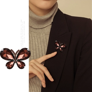 Fashion crystal butterfly brooch pin in deep red shown on blazer for elegant styling