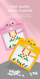 Close-up of pink and yellow chick-shaped magnetic drawing boards with colorful beads