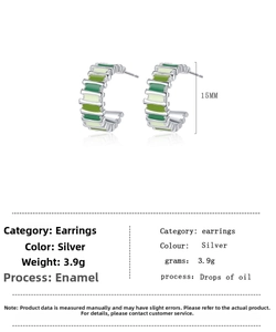 Detail view of 15mm C-shape earrings with green and white striped enamel finish