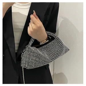 Detailed view of silver rhinestones on a black hobo bag with a silver chain strap