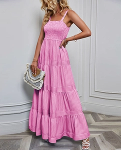 Detailed view of pink striped tiered maxi dress with pleated ruffles and spaghetti straps