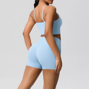 Detail view of sky blue ribbed yoga set featuring thin strap bra and seamless shorts