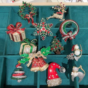 Christmas brooch collection with festive reindeer, tree, and snowman enamel pins
