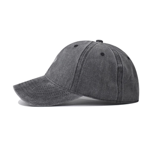 Detailed side view of washed cotton baseball cap with vintage distressed dark gray texture