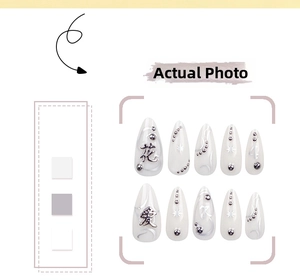 Detailed view of white press-on nails featuring silver 3D floral and love kanji charms