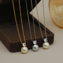 Three elegant pearl necklaces in gold and silver with zircon accents on soft velvet