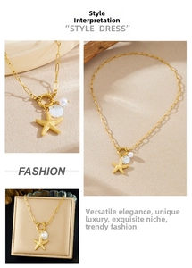 Detail of gold starfish and pearl charms with a shell pendant on a toggle link chain
