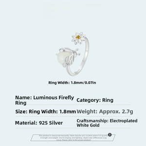 Macro detail of S925 sterling silver ring showing luminous firefly and daisy engraving