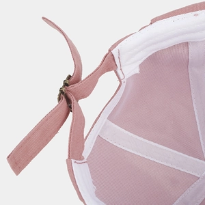 Detail of pink cotton dock cap showing metal adjustable buckle and reinforced stitching