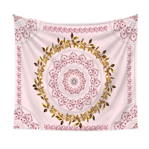 Detail of pink mandala tapestry with golden leaf motifs and floral center pattern