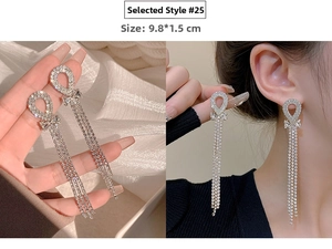 Macro detail of long silver tassel earrings with bow design and sparkling rhinestones