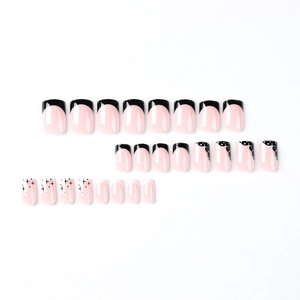 Minimalist black French tips press-on nails with star patterns on pink base