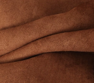 Close-up of brown faux suede fabric texture with soft matte finish and elegant folds