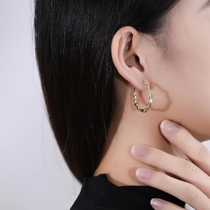 Chic S925 sterling silver hoop earrings with irregular wave texture in gold plating