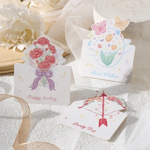 Macro detail of three watercolor floral greeting cards with Best Wishes gold ribbon decor