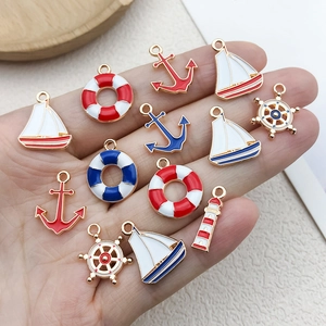 DIY mixed nautical alloy charms set with anchor sailboat and lifebuoy pendants on hand