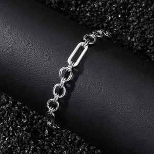 Close-up of hip hop silver geometric links on black leather and stone display stand