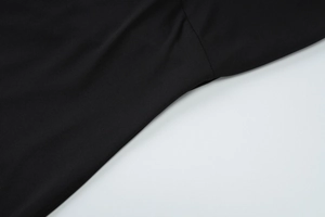 Close-up detail of high-quality stitching and fabric texture on a black sleeveless dress