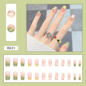 Short square press-on nails with sweet flower pattern in soft pink and green wavy edges
