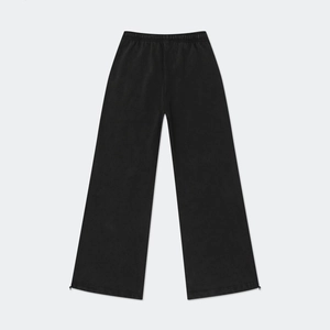 Detail of black cotton wide-leg sweatpants showing elastic waistband and drawstring