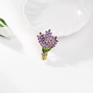 Macro view of lavender brooch with purple marquise crystals and green enamel stems