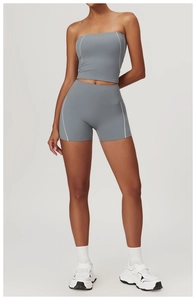 Detail of high-waisted yoga shorts and crop top with contrast white stitching