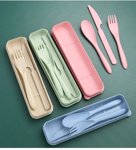 Flat lay of wheat straw cutlery sets in beige, green, pink, and blue storage cases