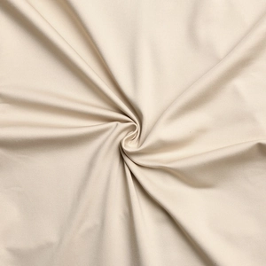Detailed macro view of beige elastic fabric texture with soft drapes and subtle gloss
