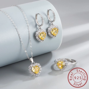 Macro detail of S925 sterling silver jewelry set with yellow heart-cut gemstones