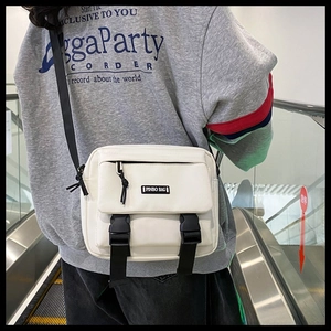 White functional crossbody bag featuring double black buckles and adjustable nylon strap