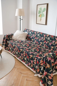 Close-up detail of vintage sunflower jacquard sofa cover with fringe trim and floral pattern
